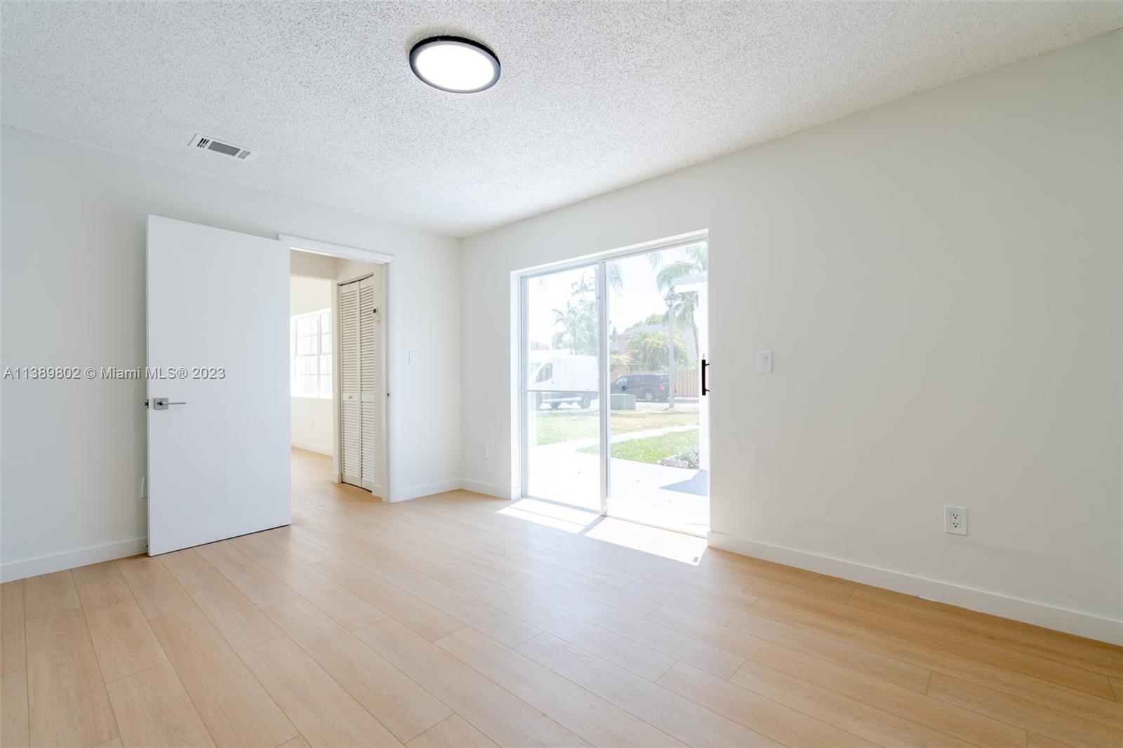 The Hammocks Miami, FL 33196 - Photo 23 of 38 an empty room with wooden floor and windows