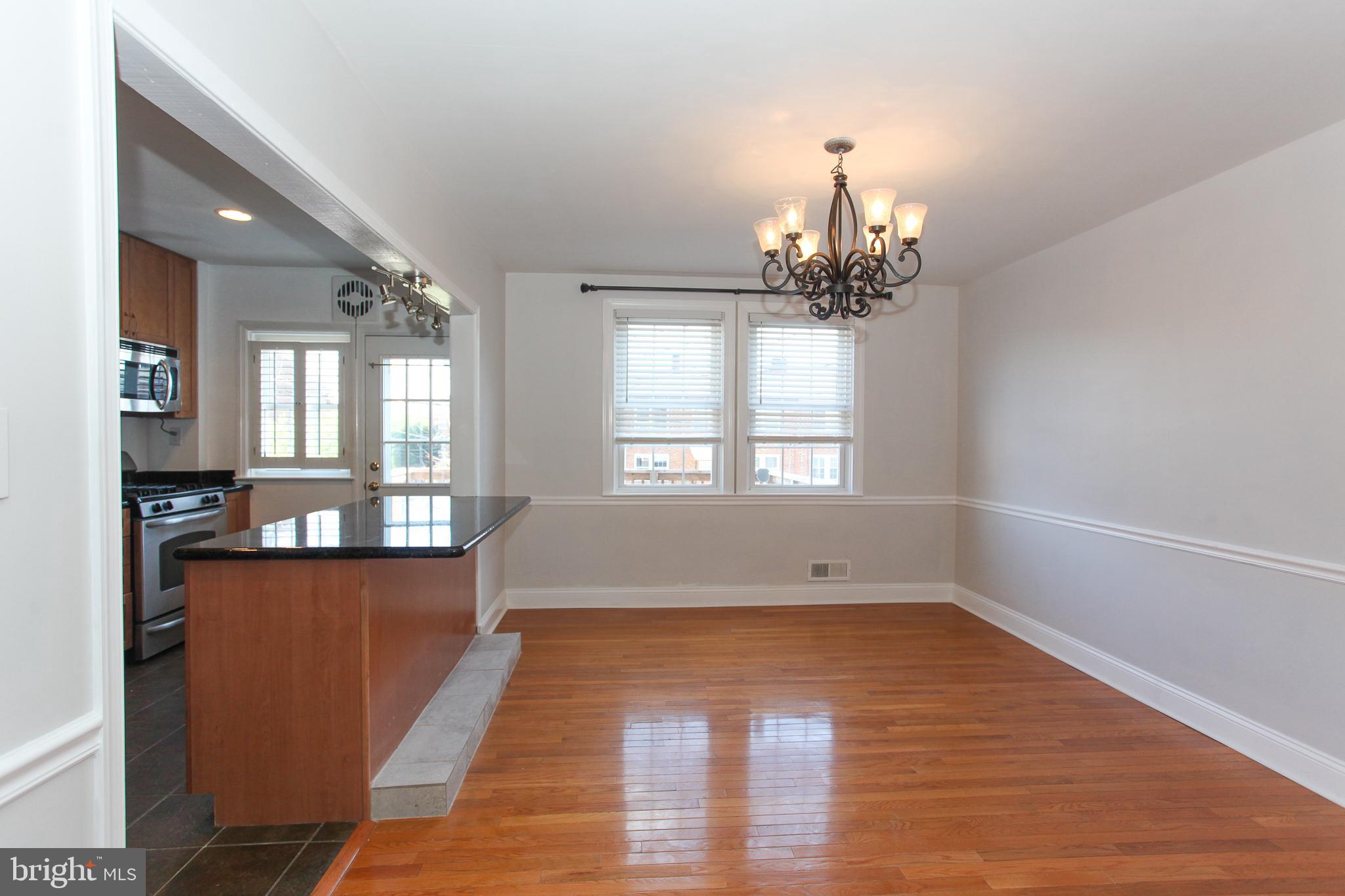 323 Greenlow Road Catonsville, MD 21228 - Photo 7 of 38 an empty room with wooden floor and windows