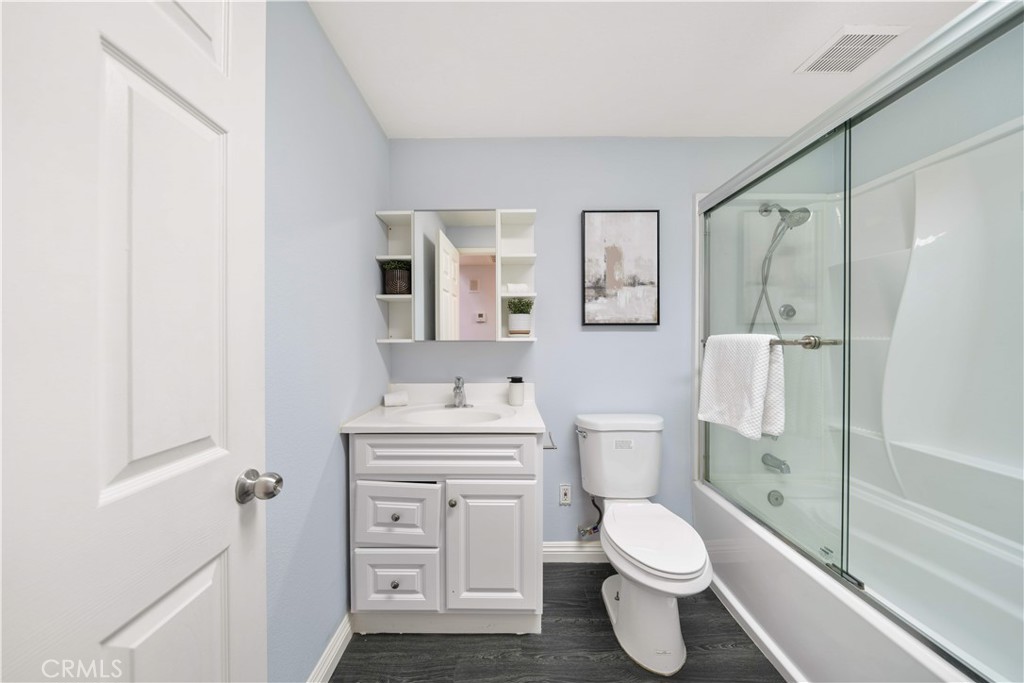 688 North Rimsdale Avenue, Unit 13 Covina, CA 91722 - Photo 12 of 52 a bathroom with a toilet sink vanity shower and mirror