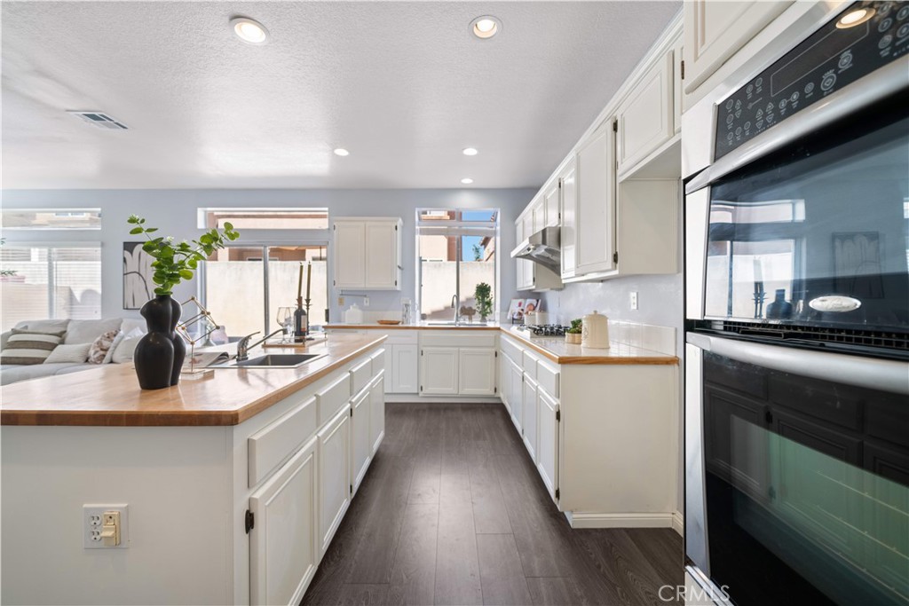 688 North Rimsdale Avenue, Unit 13 Covina, CA 91722 - Photo 16 of 52 a kitchen with white cabinets appliances and a sink