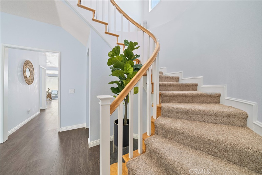 688 North Rimsdale Avenue, Unit 13 Covina, CA 91722 - Photo 22 of 52 a view of staircase with wooden floor and a potted plant