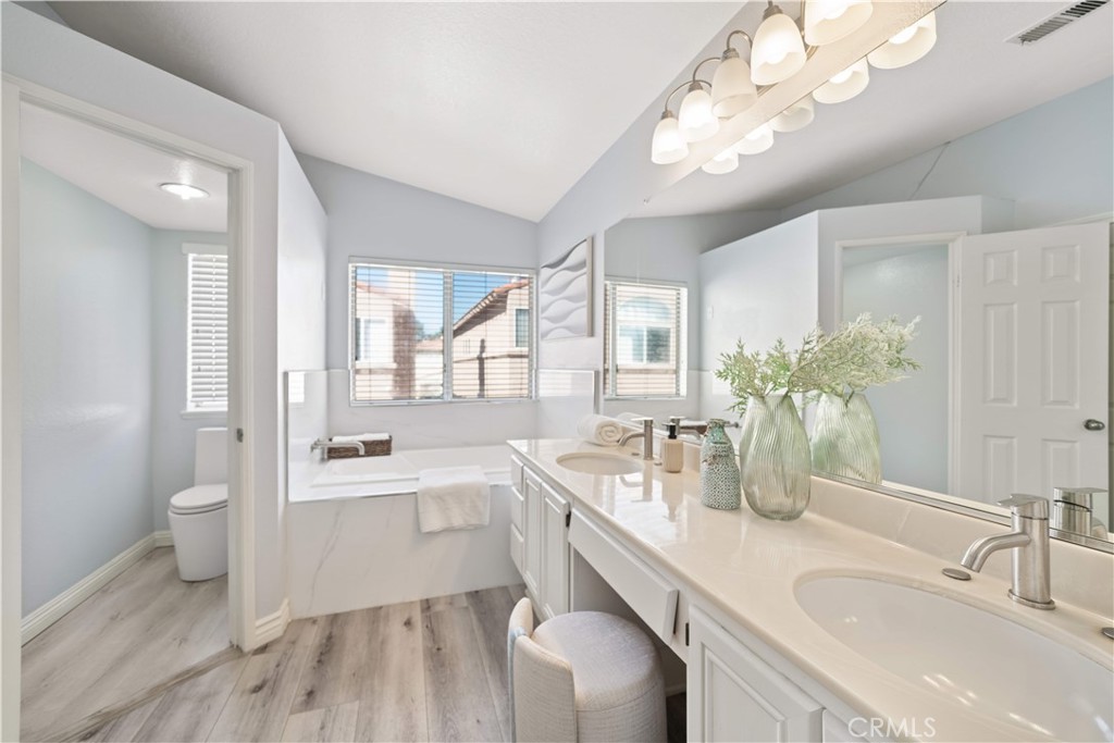688 North Rimsdale Avenue, Unit 13 Covina, CA 91722 - Photo 30 of 52 a spacious bathroom with a sink a large mirror and a toilet