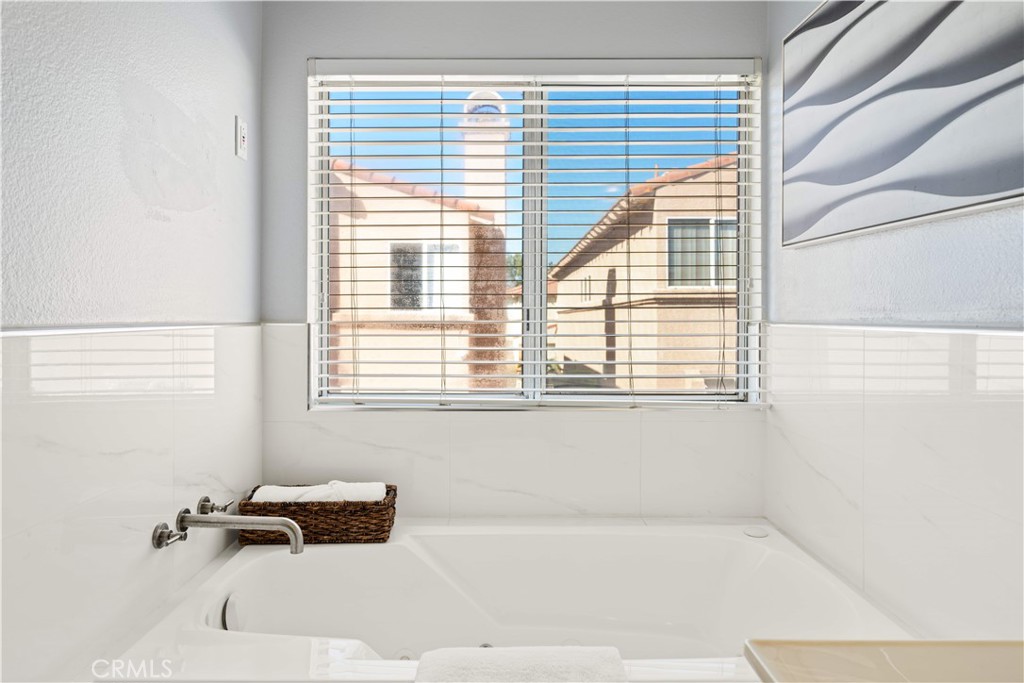 688 North Rimsdale Avenue, Unit 13 Covina, CA 91722 - Photo 32 of 52 a bathroom with a bathtub and next to a window