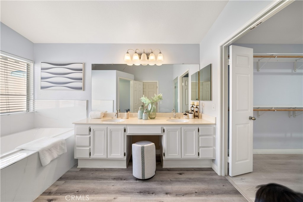 688 North Rimsdale Avenue, Unit 13 Covina, CA 91722 - Photo 33 of 52 a spacious bathroom with a tub sink and mirror