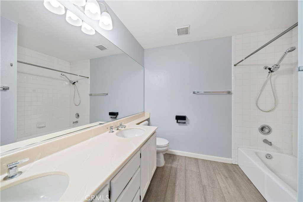 688 North Rimsdale Avenue, Unit 13 Covina, CA 91722 - Photo 41 of 52 a bathroom with a tub a sink and a large mirror