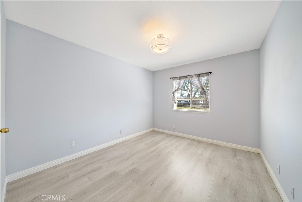 688 North Rimsdale Avenue, Unit 13 Covina, CA 91722 - Photo 44 of 52 an empty room with wooden floor and windows