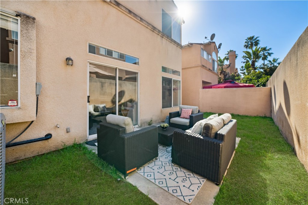 688 North Rimsdale Avenue, Unit 13 Covina, CA 91722 - Photo 50 of 52 a backyard of a house with table and sofas