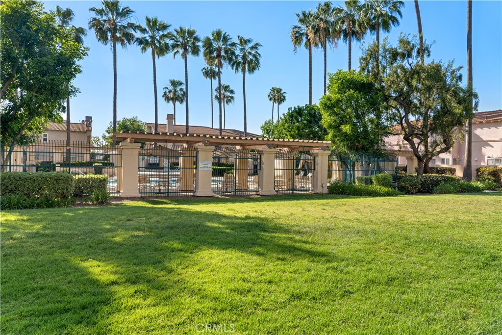 688 North Rimsdale Avenue, Unit 13 Covina, CA 91722 - Photo 52 of 52 a view of a house with a yard and palm trees