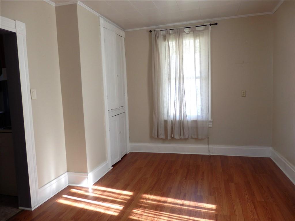 621 Williams Street Confluence, PA 15424 - Photo 11 of 21 a view of an empty room with wooden floor and a window
