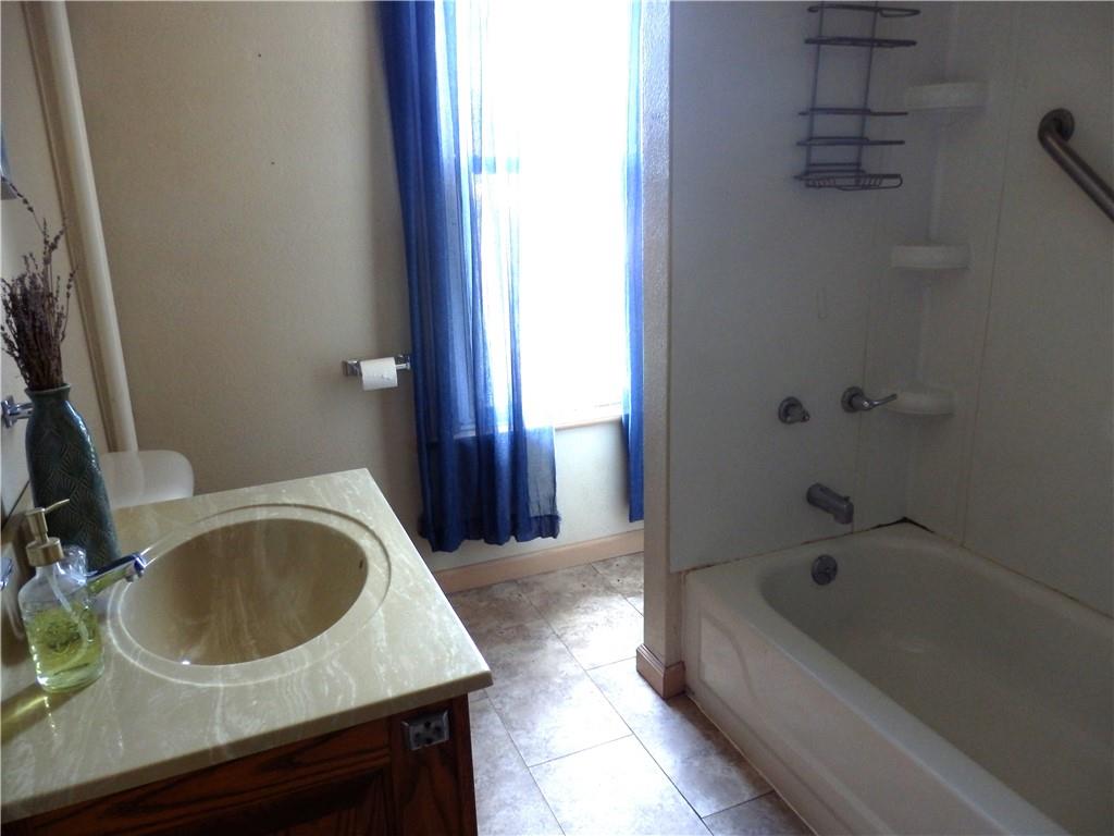 621 Williams Street Confluence, PA 15424 - Photo 18 of 21 a bathroom with a sink a bathtub and toilet