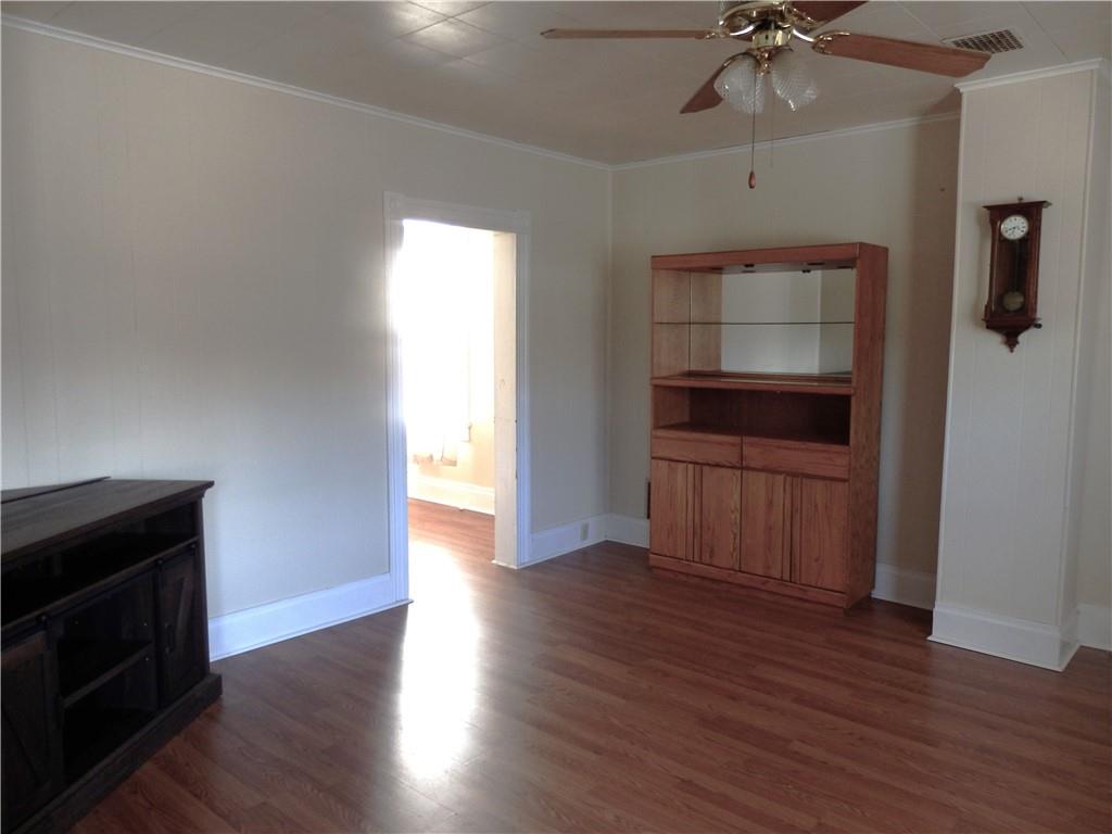 621 Williams Street Confluence, PA 15424 - Photo 9 of 21 a view of an empty room with a fireplace and wooden floor