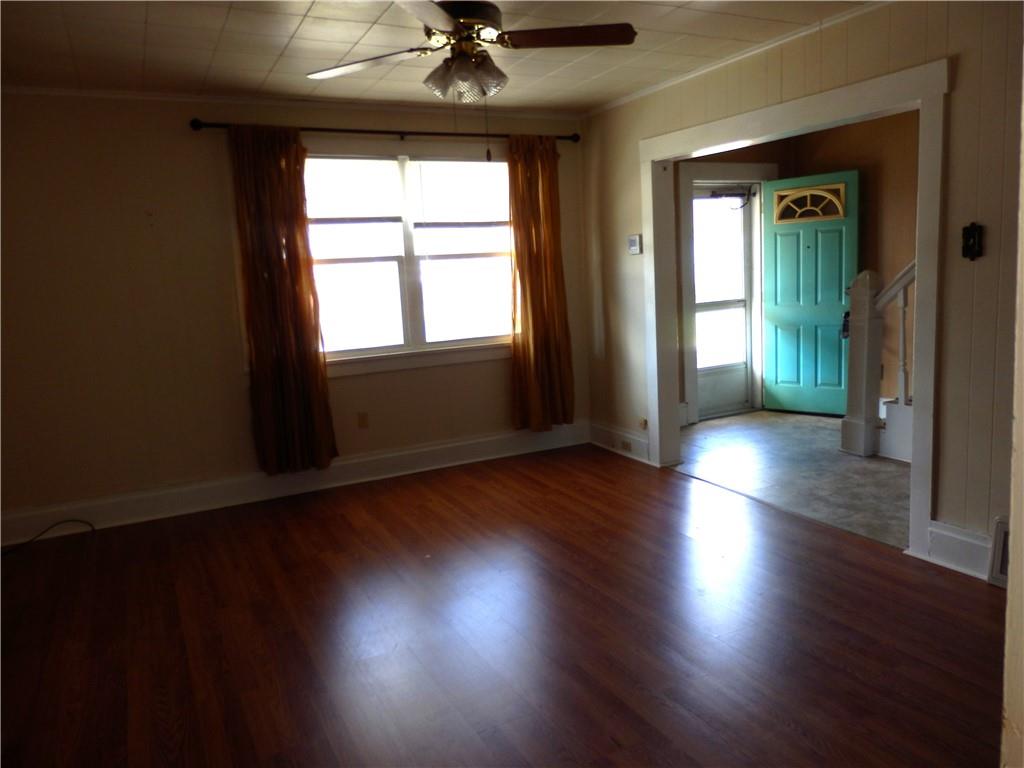 621 Williams Street Confluence, PA 15424 - Photo 10 of 21 an empty room with wooden floor fan and windows