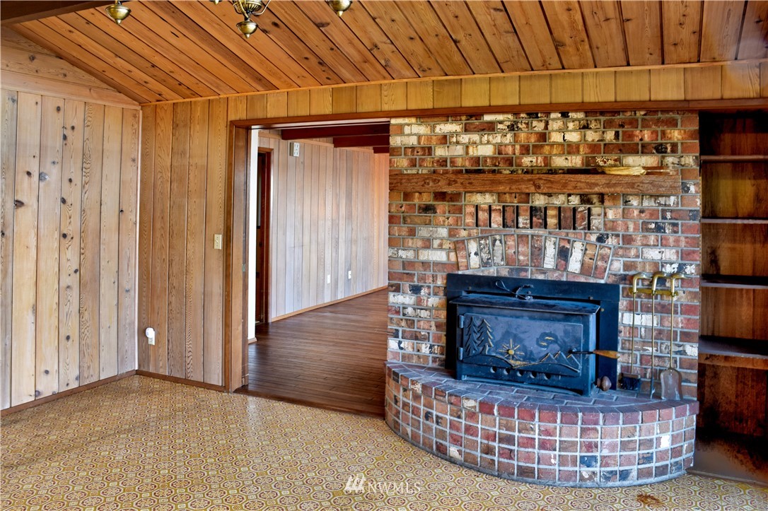 7130 Sandy Point Road Northeast Olympia, WA 98516 - Photo 14 of 32 a room with fireplace and furniture