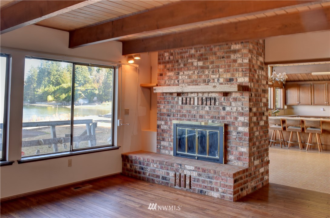 7130 Sandy Point Road Northeast Olympia, WA 98516 - Photo 15 of 32 a living room with furniture and a fireplace