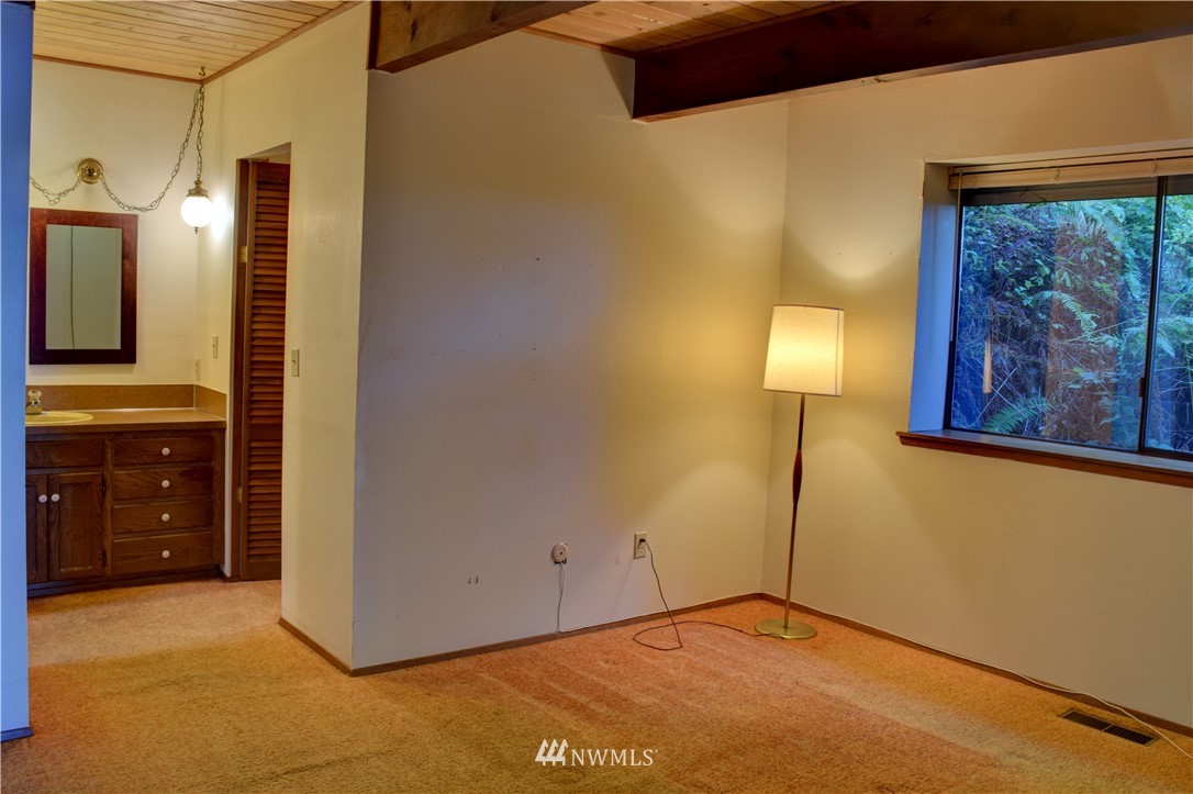 7130 Sandy Point Road Northeast Olympia, WA 98516 - Photo 18 of 32 a view of a bathroom with a sink and a mirror