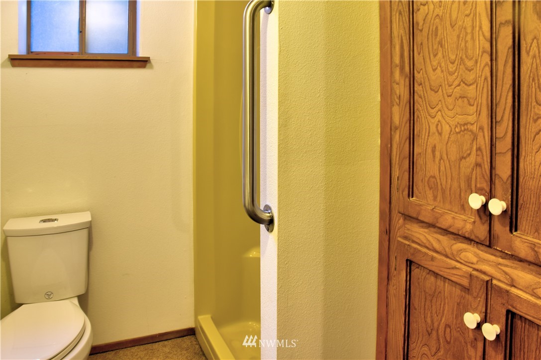 7130 Sandy Point Road Northeast Olympia, WA 98516 - Photo 19 of 32 a bathroom with a toilet and shower