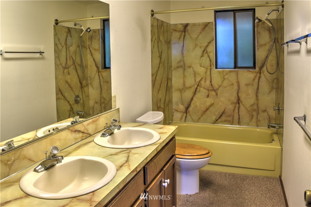 7130 Sandy Point Road Northeast Olympia, WA 98516 - Photo 23 of 32 a bathroom with a sink toilet and shower