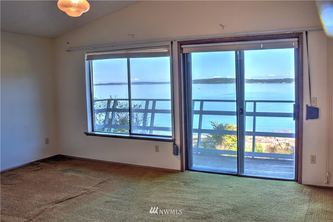 7130 Sandy Point Road Northeast Olympia, WA 98516 - Photo 25 of 32 an empty room with windows and entrance