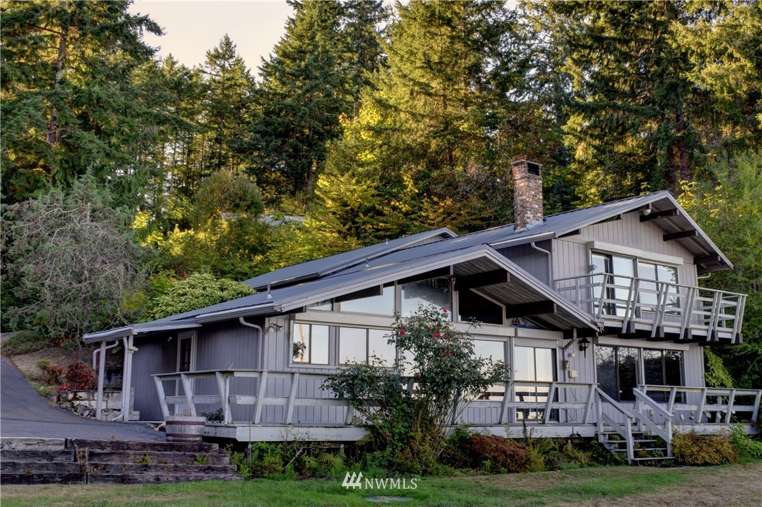 7130 Sandy Point Road Northeast Olympia, WA 98516 - Photo 4 of 32 a front view of a house with garden