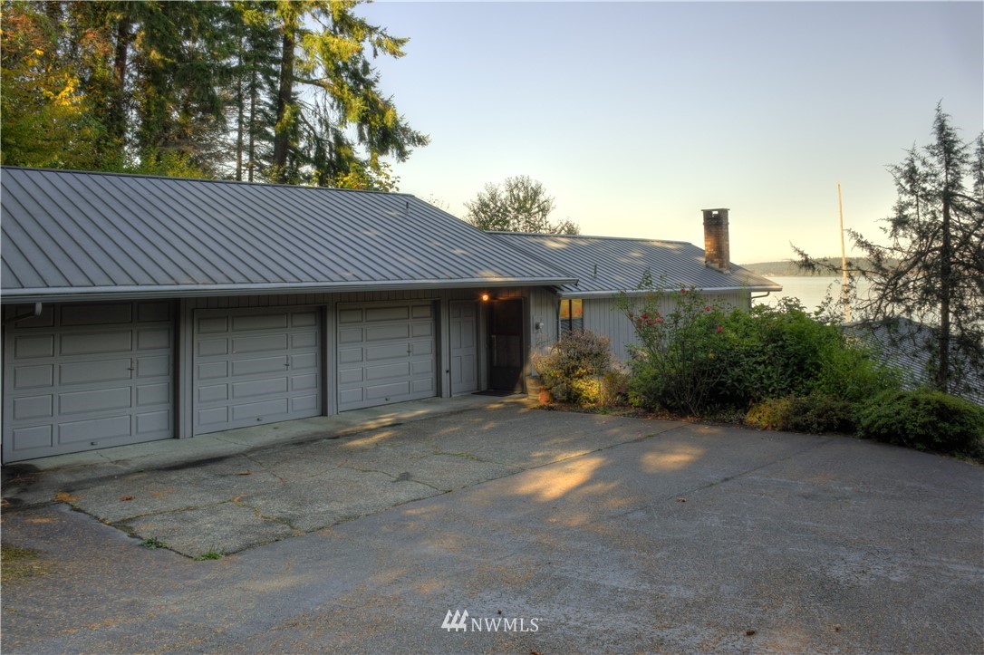 7130 Sandy Point Road Northeast Olympia, WA 98516 - Photo 6 of 32 a view of a house with a yard and garage