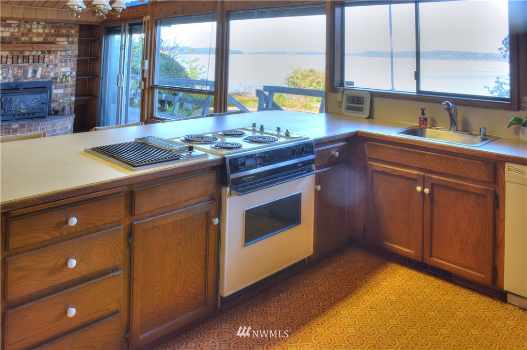 7130 Sandy Point Road Northeast Olympia, WA 98516 - Photo 10 of 32 a kitchen that has a sink and a stove