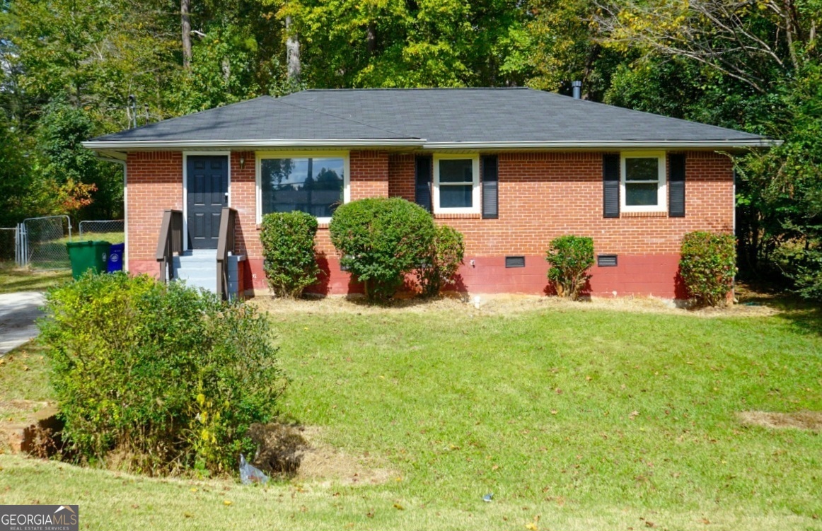 a front view of house with yard and staircase