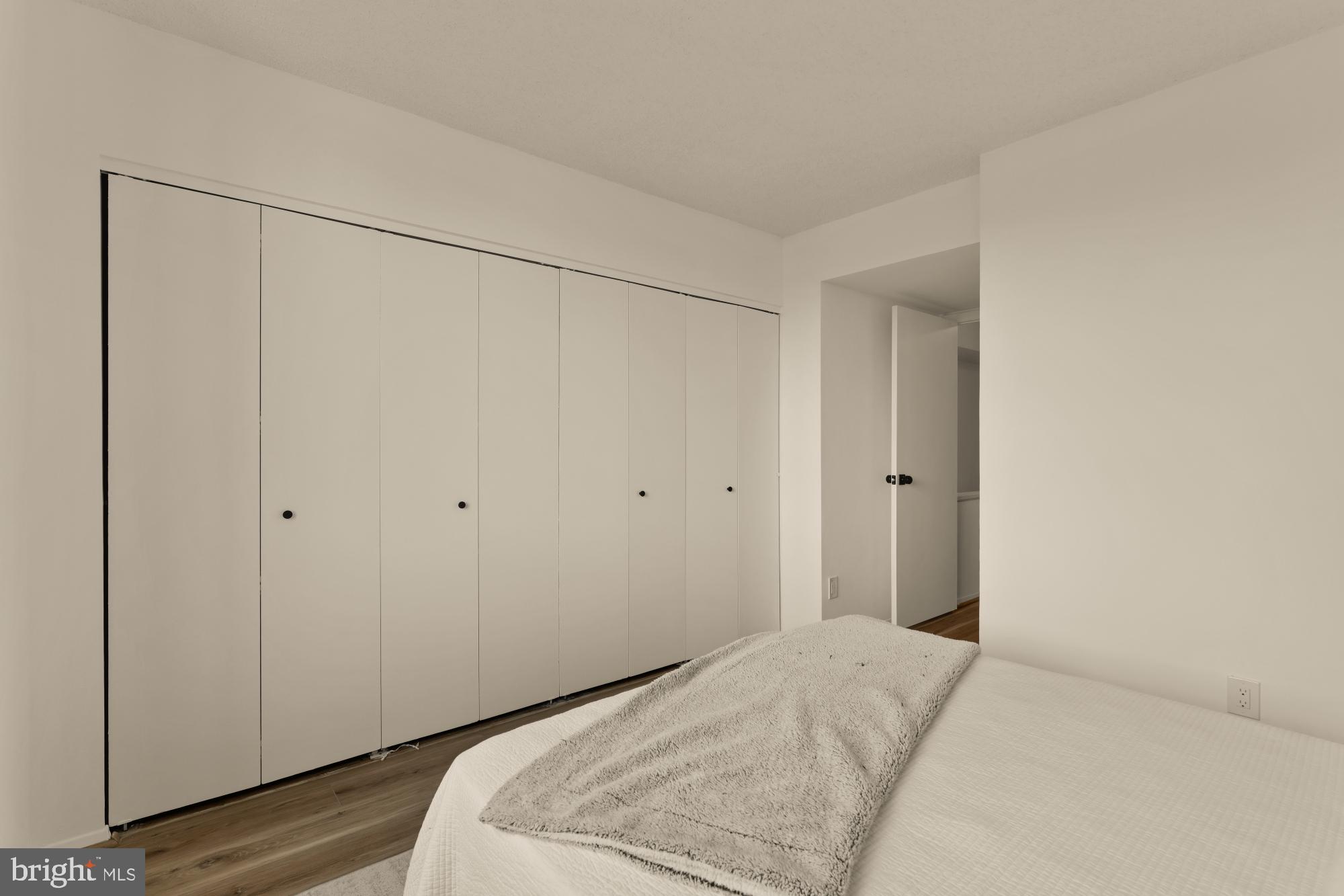 1245 13th Street Northwest, Unit 907 Washington, DC 20005 - Photo 11 of 27 a bedroom with a bed and wooden floor