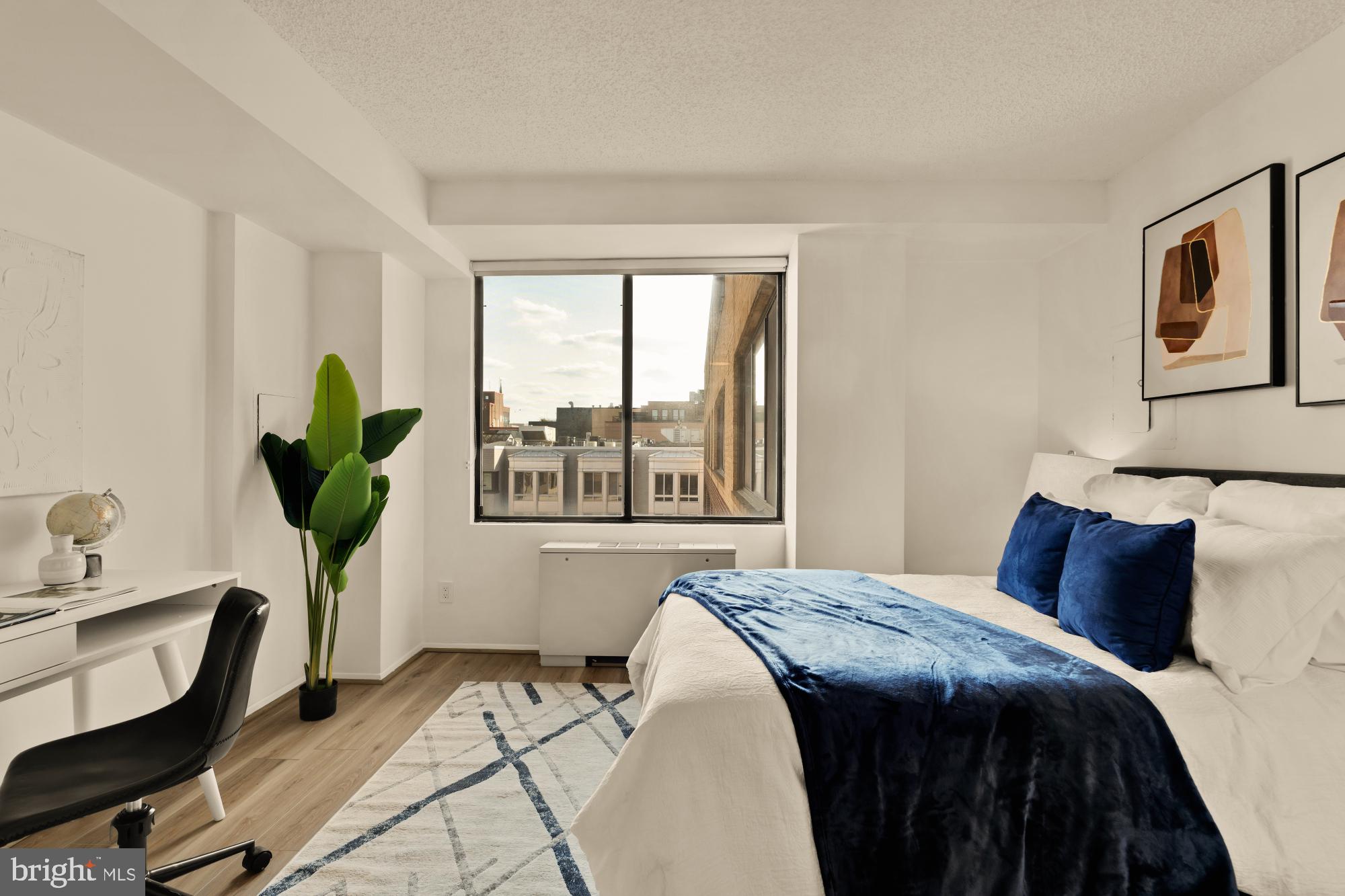 1245 13th Street Northwest, Unit 907 Washington, DC 20005 - Photo 12 of 27 a bedroom with a bed a chandelier and a window