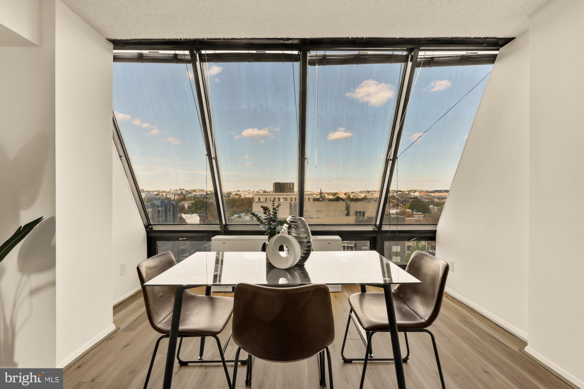 1245 13th Street Northwest, Unit 907 Washington, DC 20005 - Photo 3 of 27 a view of a dining room with furniture and wooden floor