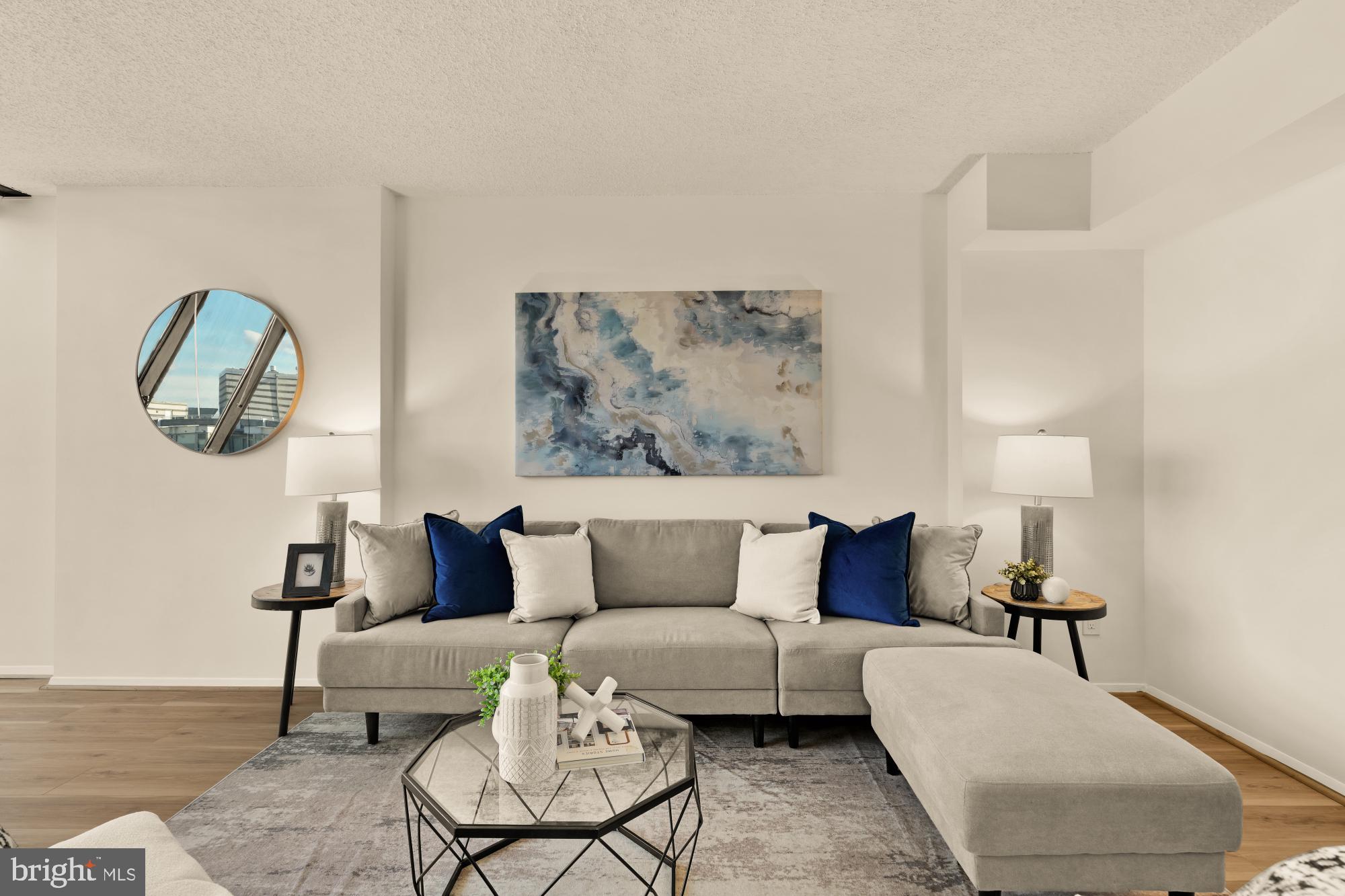 1245 13th Street Northwest, Unit 907 Washington, DC 20005 - Photo 5 of 27 a living room with furniture and a lamp