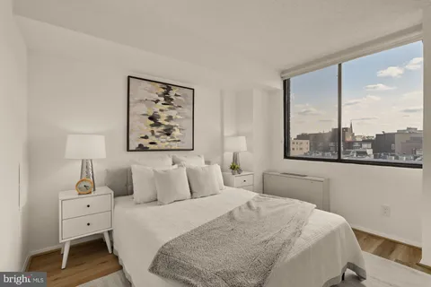 a bedroom with a large bed and a window