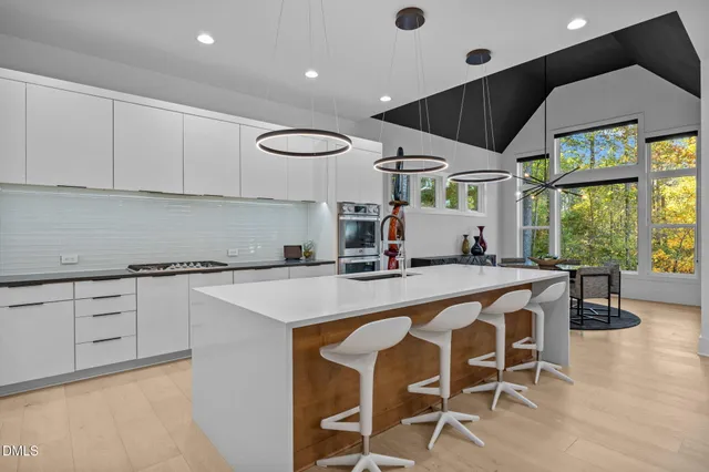 a kitchen with stainless steel appliances a sink and a refrigerator