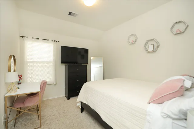 a bedroom with a bed and a chair