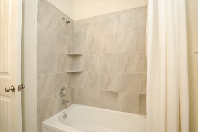 a bathroom with a bathtub and shower