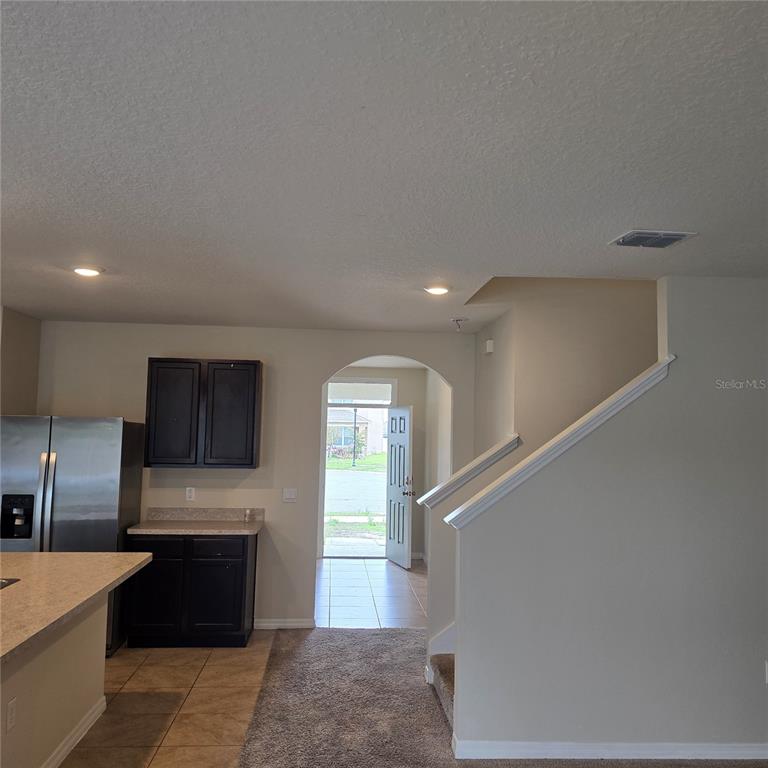 814 Sun Burst Road Winter Haven, FL 33880 - Photo 11 of 48 a view of a kitchen with a sink and dishwasher a refrigerator with wooden floor