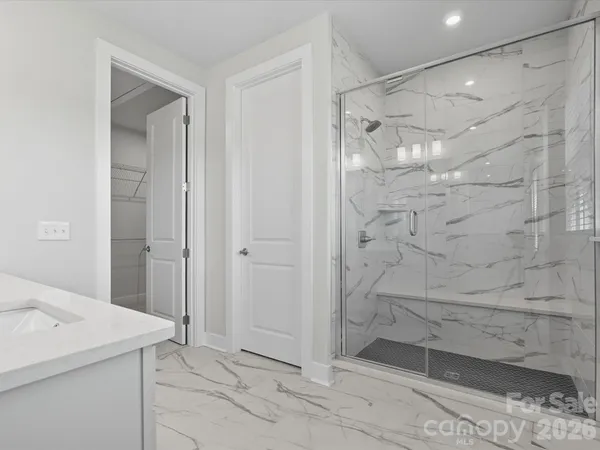 a spacious bathroom with a sink mirror and a window