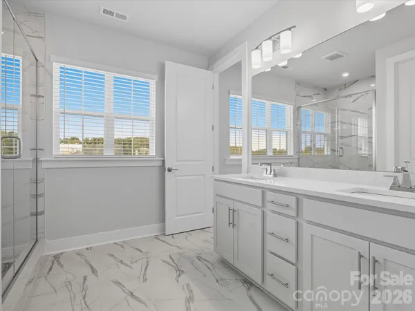 a bathroom with a sink a toilet and a large mirror