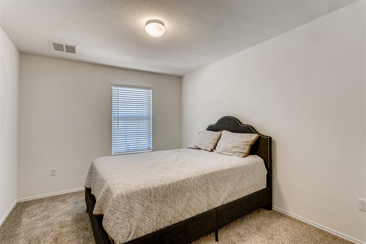 3901 Fort Collins Way Austin, TX 78744 - Photo 16 of 26 a bedroom with a bed and window