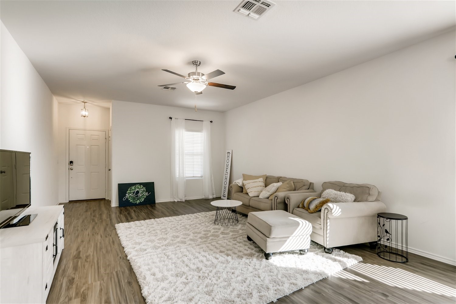 3901 Fort Collins Way Austin, TX 78744 - Photo 5 of 26 a living room with furniture and a flat screen tv