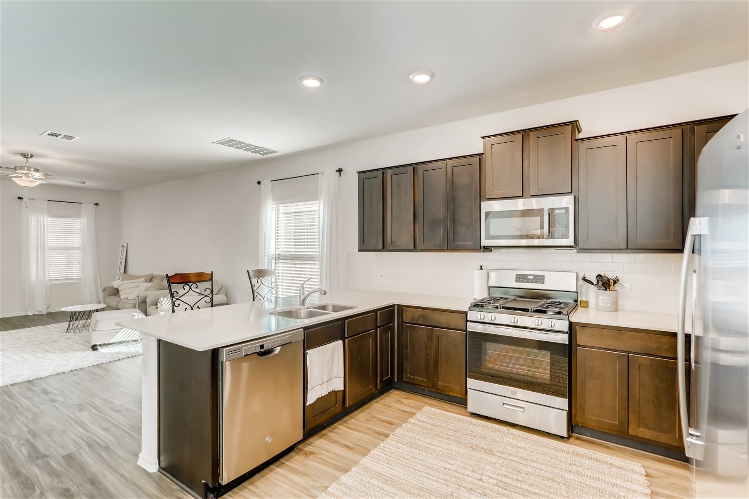 3901 Fort Collins Way Austin, TX 78744 - Photo 8 of 26 a kitchen with a sink stove top oven and refrigerator