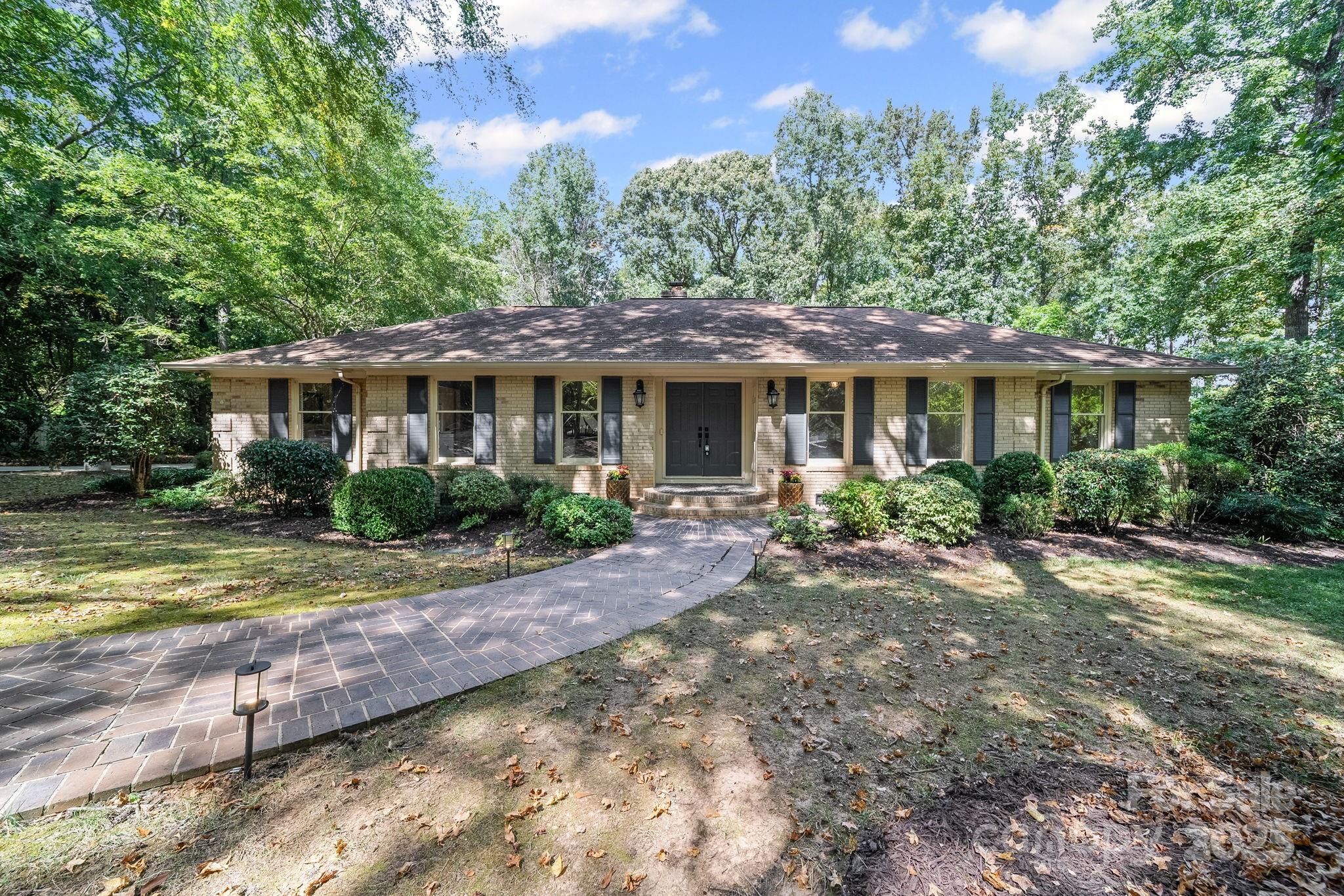 a patio with a table and chairs under an umbrella