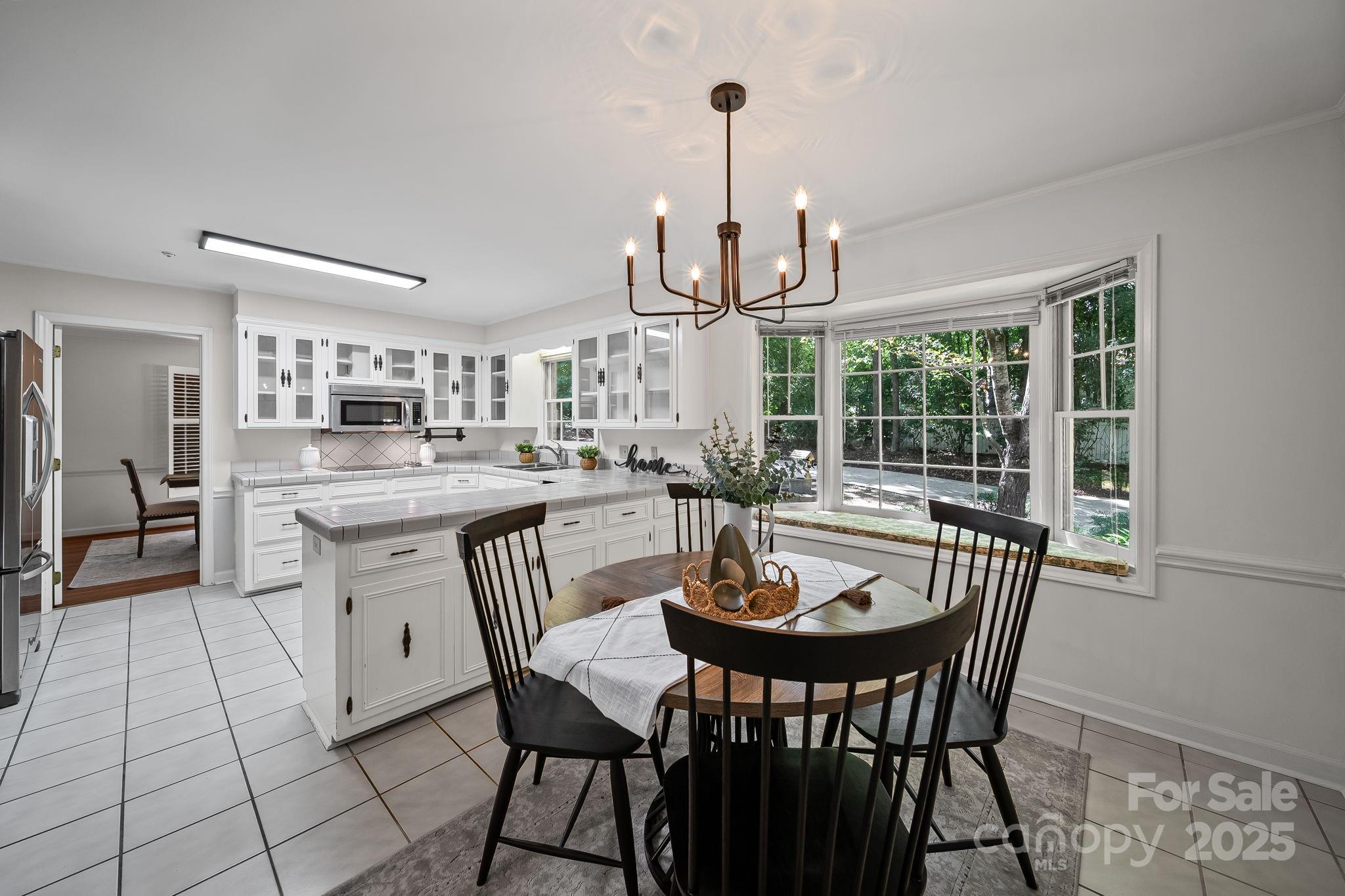 1676 Partridge Circle Lancaster, SC 29720 - Photo 13 of 43 a kitchen with a dining table chairs and stove