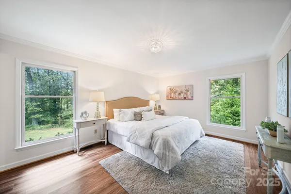 a bedroom with a bed and a large window