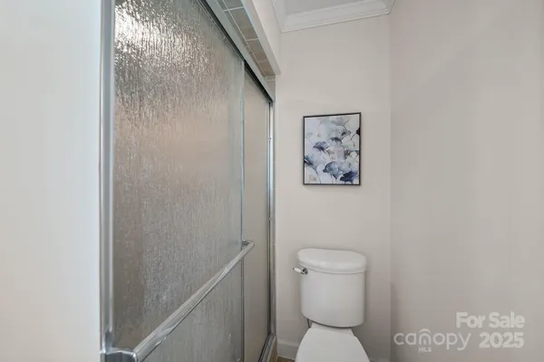 a bathroom with a toilet and a shower