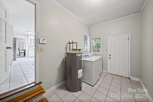 a room with a washing machine and cabinets