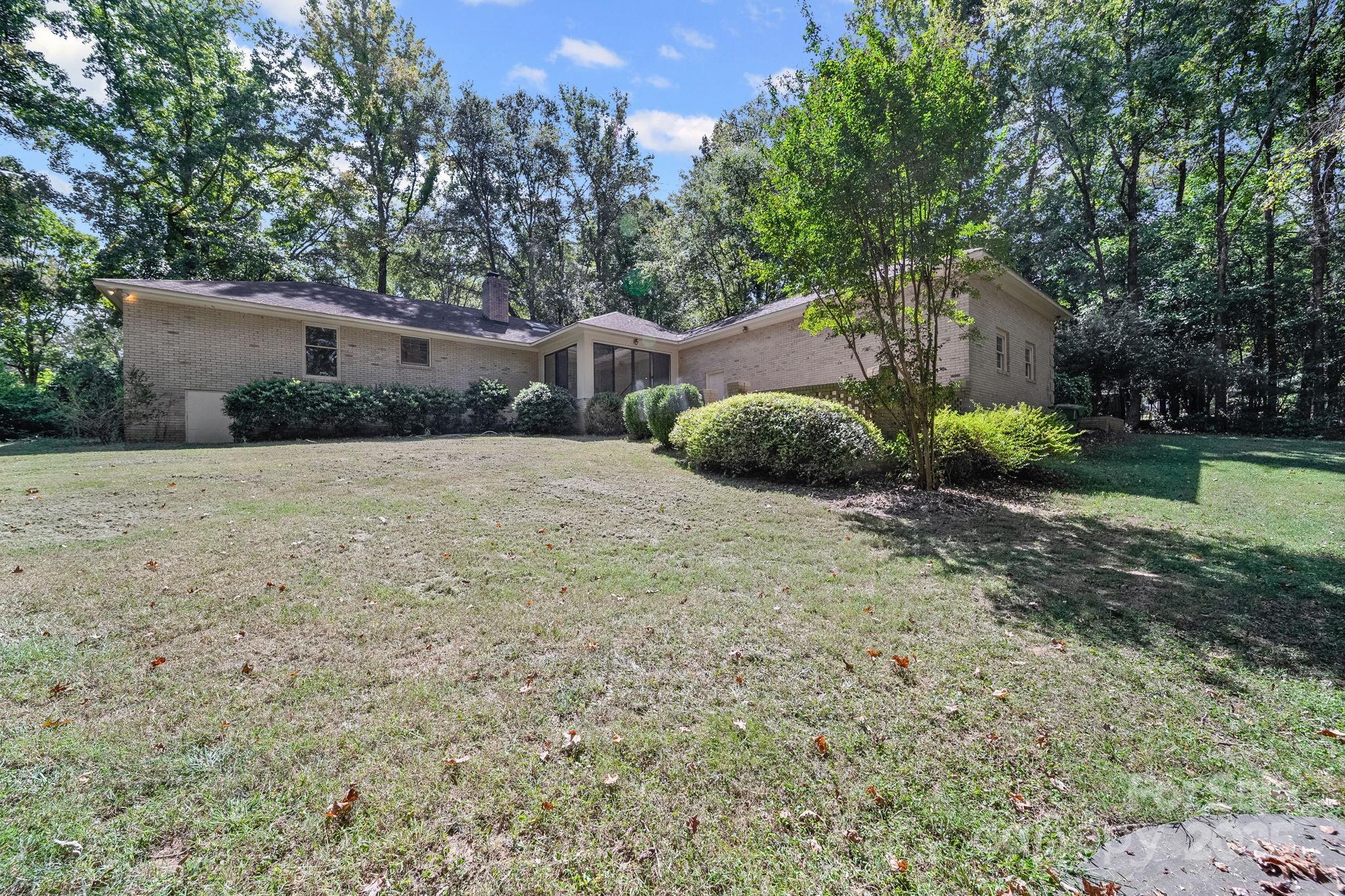 1676 Partridge Circle Lancaster, SC 29720 - Photo 35 of 43 a backyard of a house with plants and large trees