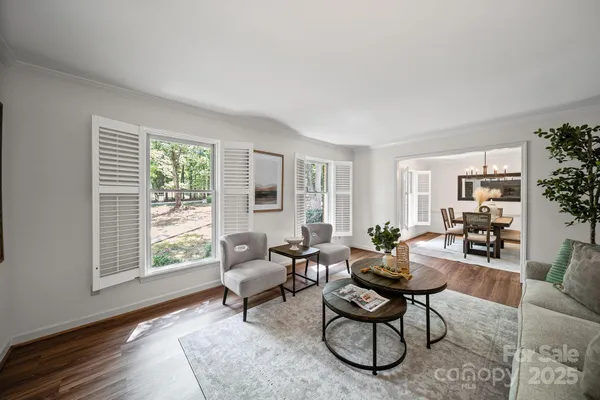 a living room with furniture a rug and a large window