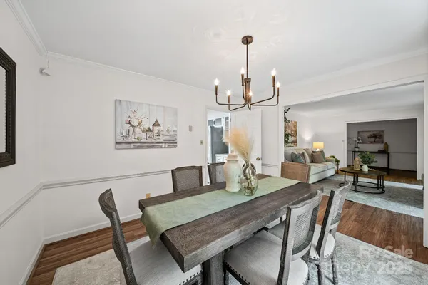 a dining room with furniture and wooden floor