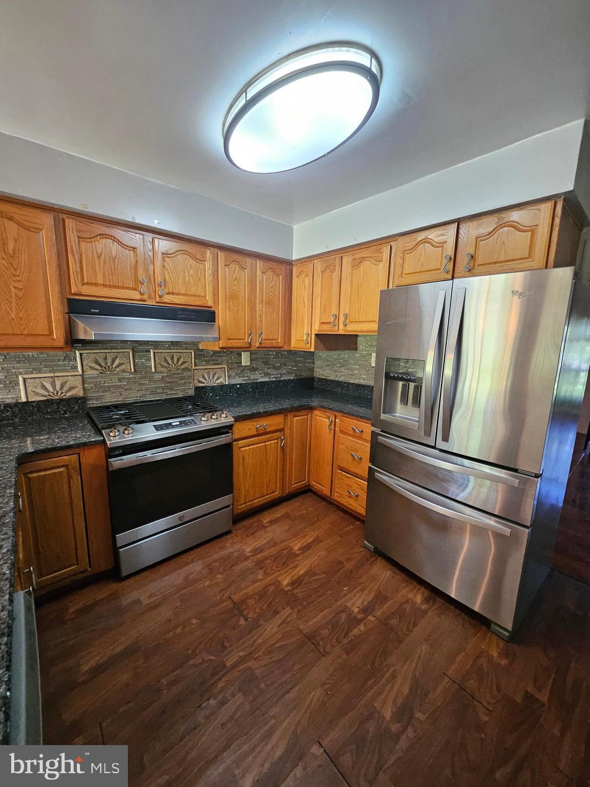 148 Church Road Elkins Park, PA 19027 - Photo 33 of 33 a kitchen with granite countertop stainless steel appliances and wooden cabinets