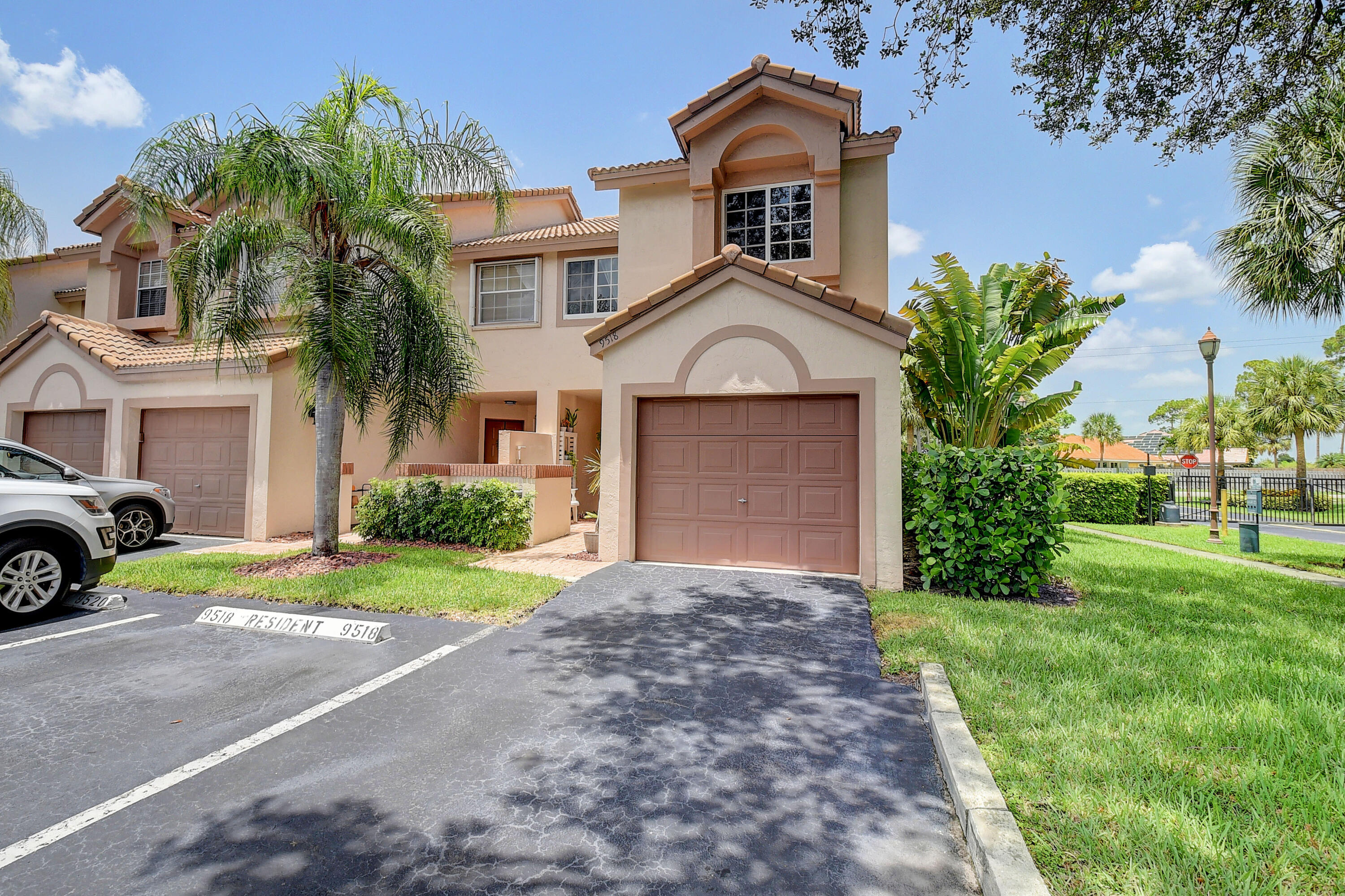 9518 Boca River Circle Boca Raton, FL 33434 - Photo 3 of 34 a front view of a house with a yard and garage